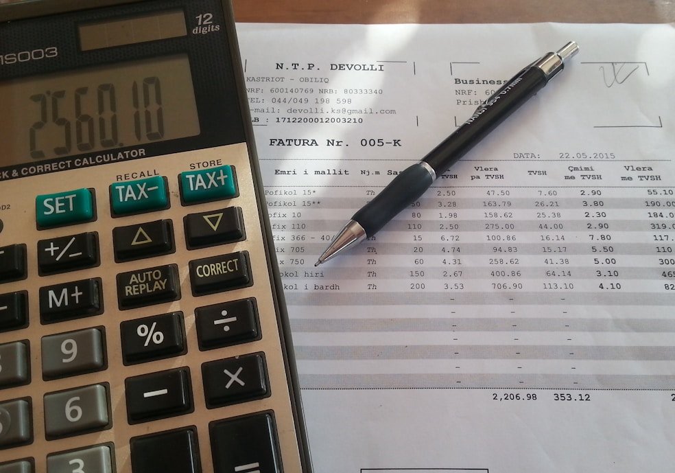 A calculator and a prepared tax return on a desk at the EazyTaxRefund office